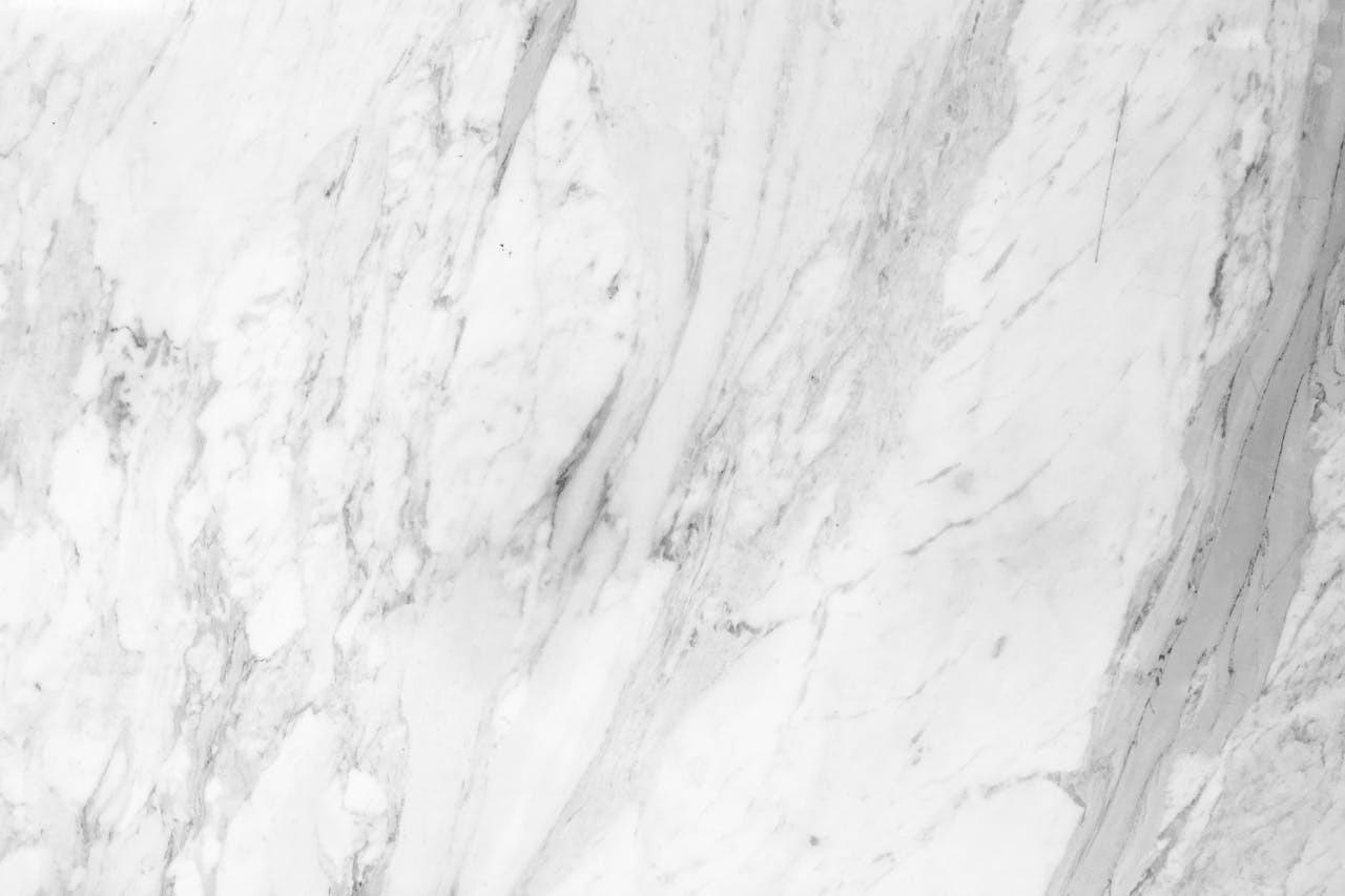 heros-img High-resolution white marble texture with natural patterns, perfect for backgrounds.
